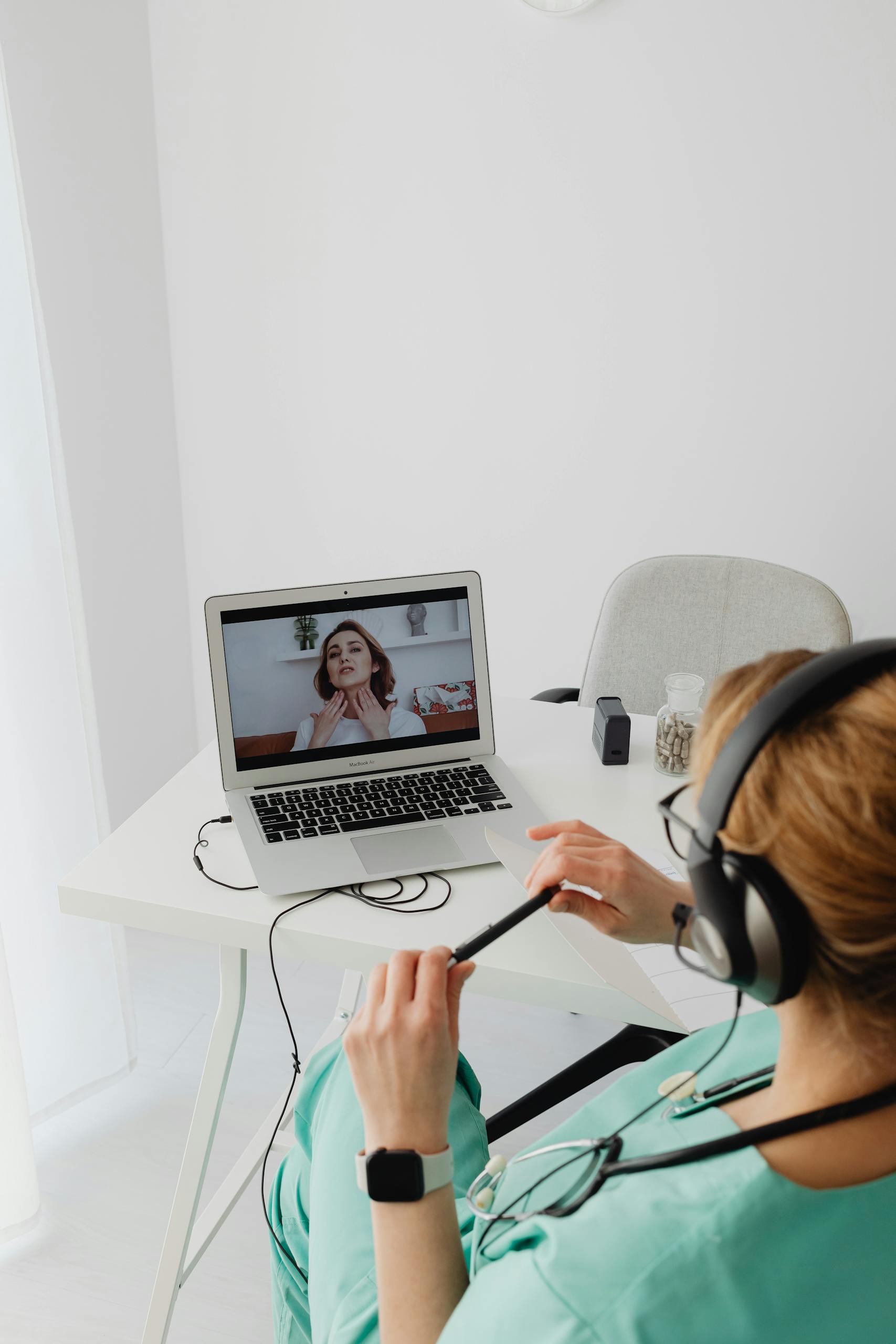 A patient video calls a doctor using a laptop for an online consultation.